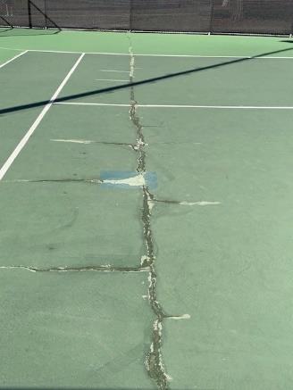 A worn playing surface at the Camino Real Park tennis courts, the home of public tennis in Ventura for generations